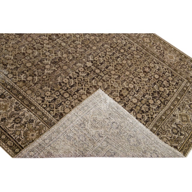 Beautiful antique Malayer hand-knotted wool rug with a brown color field. This Malayer piece has a designed frame with...
