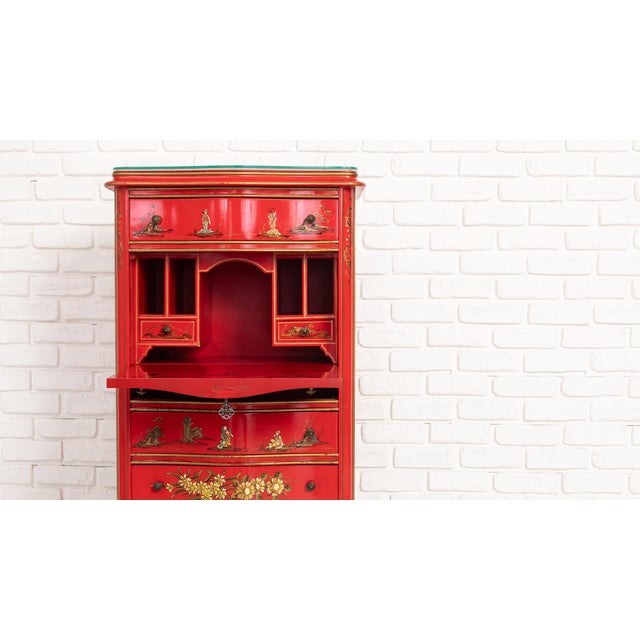 Decorative three-piece red lacquer chinoiserie set consisting of a tall secretary chest and two matching side tables. The...