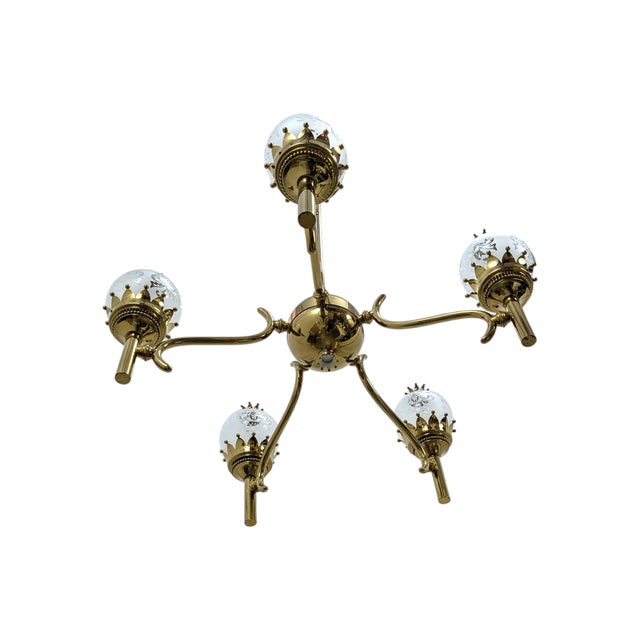 This is a polished brass pendant lamp with a sturdy central structure and five curved arms. The design features five...