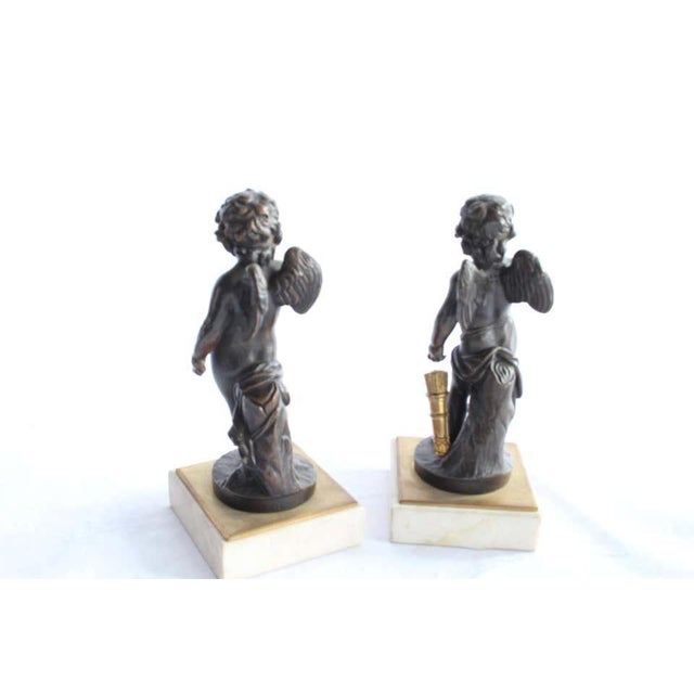 A pair of french bronze figures of winged cherubs. French first half of the 19th century. Dark brown patination. Each...