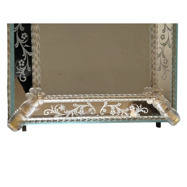 This elegant Venetian mirror is a stunning example of traditional Italian craftsmanship. The rectangular central glass is...