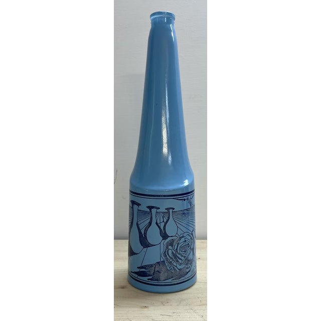 This is a set of 3 blue bottles designed by Salvador Dali for Rosso Antico . Rosso Antico is a dessert wine produced in...