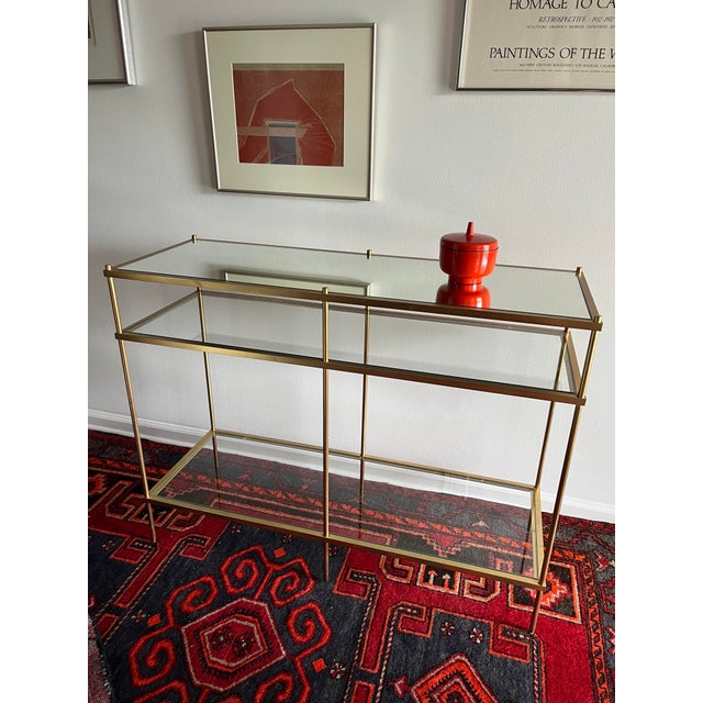 Elegant Williams Sonoma Home console table from the Terrace collection, featuring a slender brass-finish metal frame with...