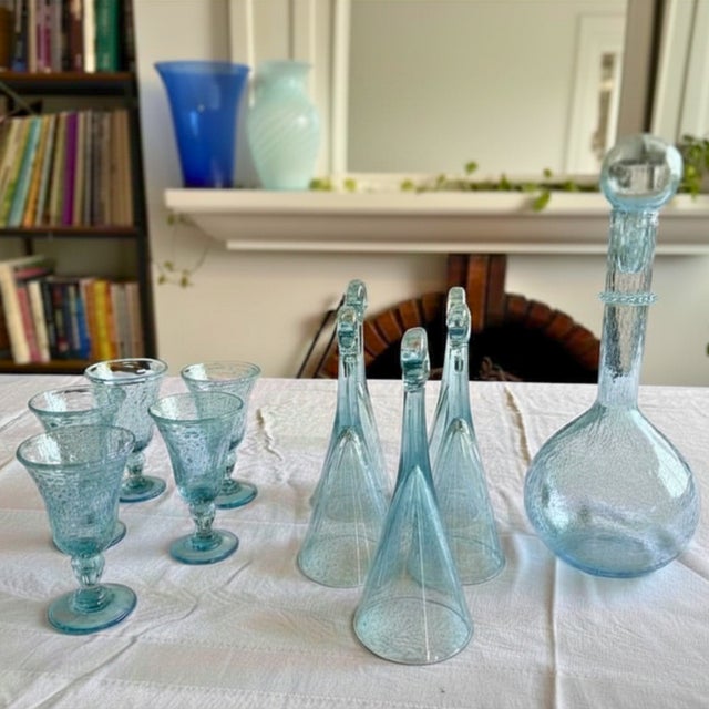 A luminous and poetic ensemble in pale blue bubbled glass, capturing the effortless elegance of the French Riviera. This...