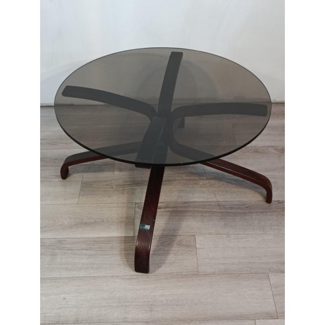 Magnificent coffee table by Sigurd Ressell for Vatne Mobler. Norway, 1970s. Wooden frame supporting a thick smoked glass...