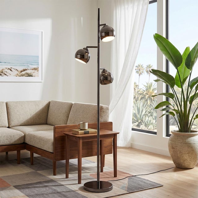 The Triplet Floor Lamp is a Peter Morelli-designed Mid-Century Modern floor lamp crafted with black nickel Steel,...