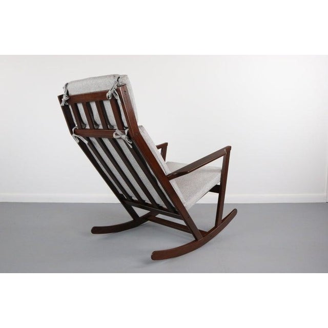 Dramatic lines on this well sculpted architectural afromosia frame w/ new light grey knit upholstery.