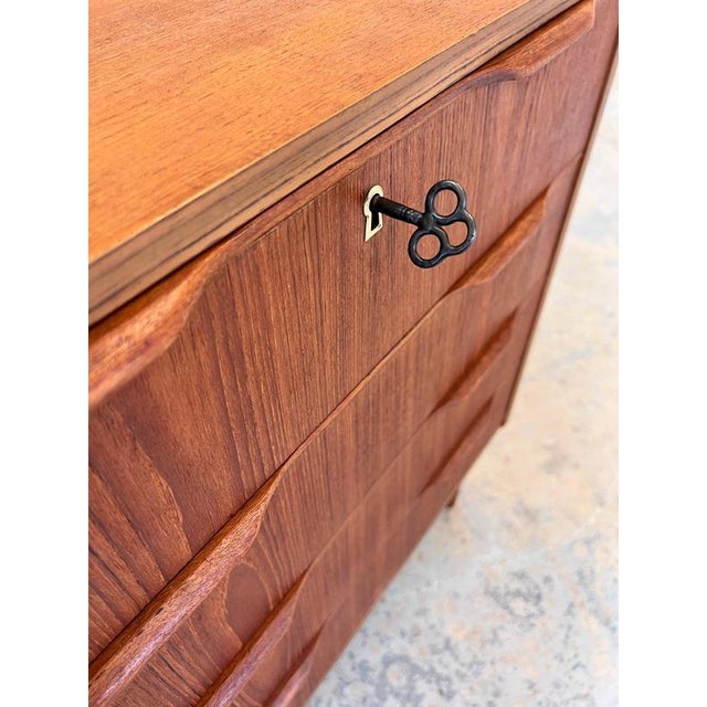 This Danish chest of drawers from the mid-century era combines classic Scandinavian craftsmanship with exceptionally fine...