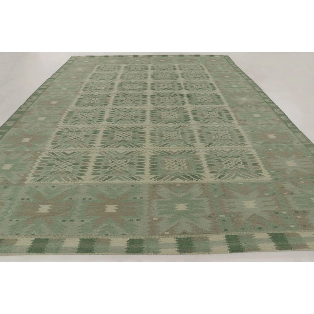 gHandwoven in wool and exotic yarn, this oversized 12x16 Scandinavian rug features a balanced geometric design in soothing...
