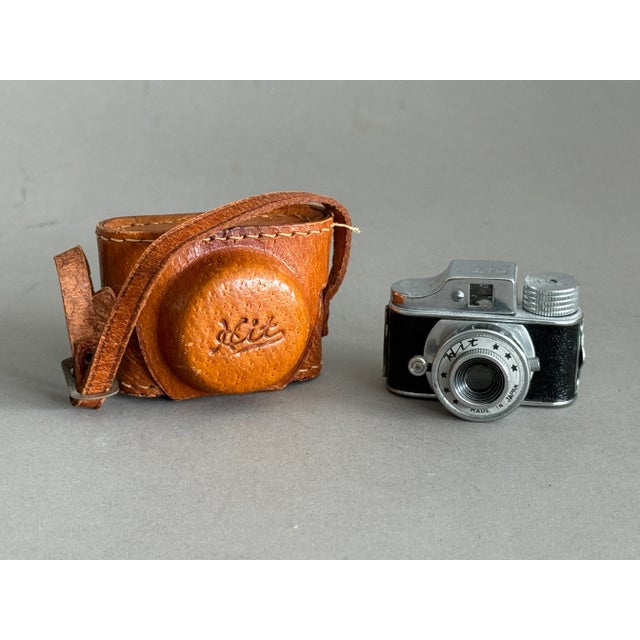 This tiny camera is so cute. It would be a great addition to any camera collection. Looks great in a mid-century modern...