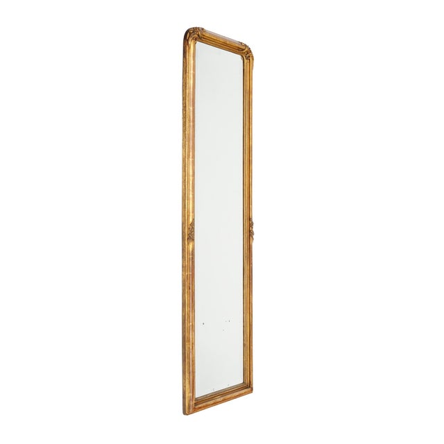 Louis Philippe floor mirror with a wooden frame showcasing hand-carved floral details and curved upper corners. The frame...