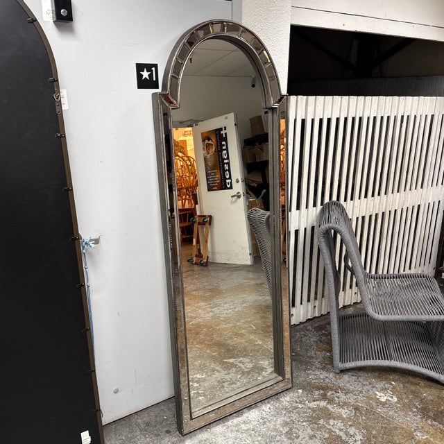 Design Plus Gallery presents a Bacavi Arch Floor Mirror by Uttermost. A tall architectural profile accented by an arched...