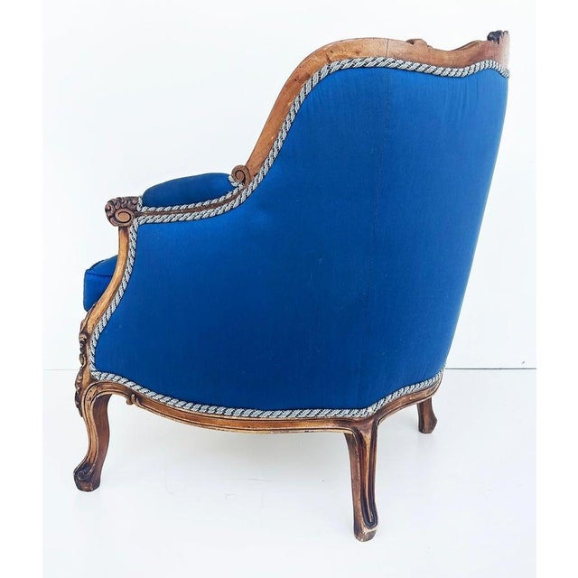 1920s Carved Walnut French Bergeres Armchairs Upholstered in Silk, a Pair Offered for sale is a pair of French hand-carved...