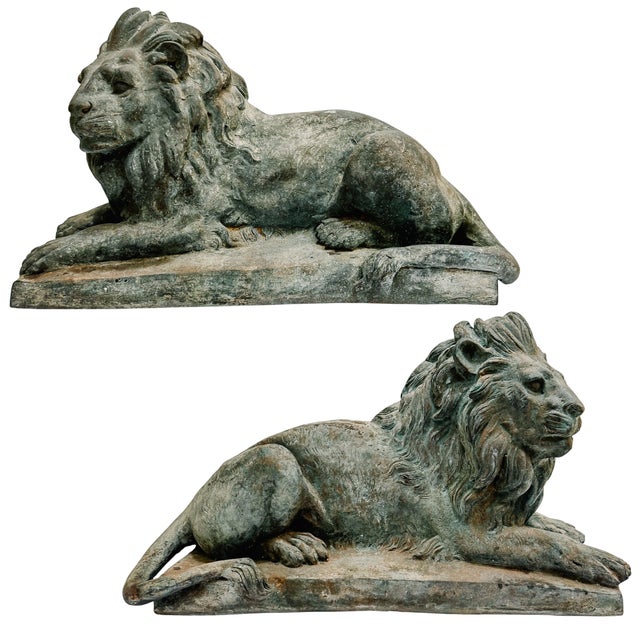 An impressive pair of early to mid 20th century continental European recumbent lions, cast in the grand Neoclassical...