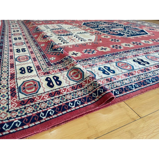 This beautiful Shirvan rug is fully hand-knotted using high-quality wool, featuring a bold tribal design with three...