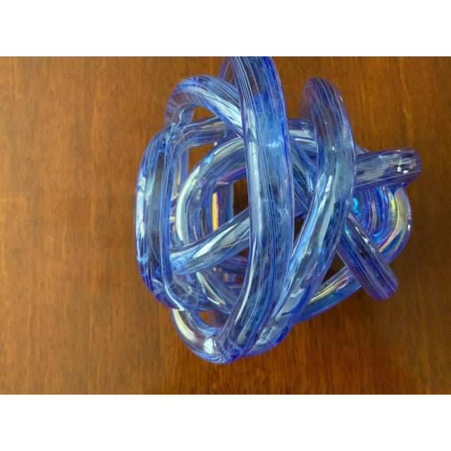 Gorgeous hand blown iridescent, knot styled after Marano glass perfect accessory for a bookshelf. Substantial in weight.
