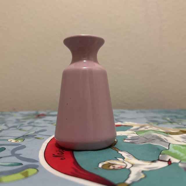 This elegant ceramic bud vase features a clean, minimalist silhouette with a flared rim and gently tapered body. Finished...