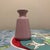 This elegant ceramic bud vase features a clean, minimalist silhouette with a flared rim and gently tapered body. Finished...