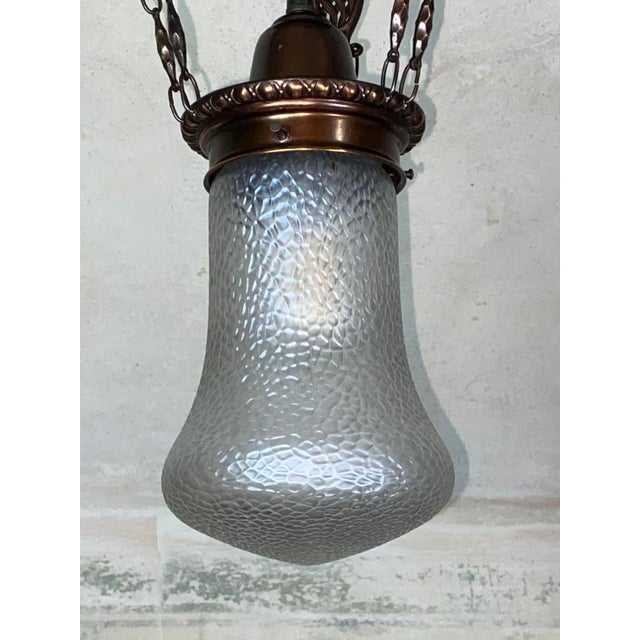 In perfect original condition. Perfectly cleaned, new wiring. Iridescent glass made by Loetz, Martelé decor body made of...