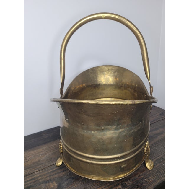 Add a touch of Regency elegance to your home with this substantial vintage brass scuttle. Featuring an oval, hand-hammered...