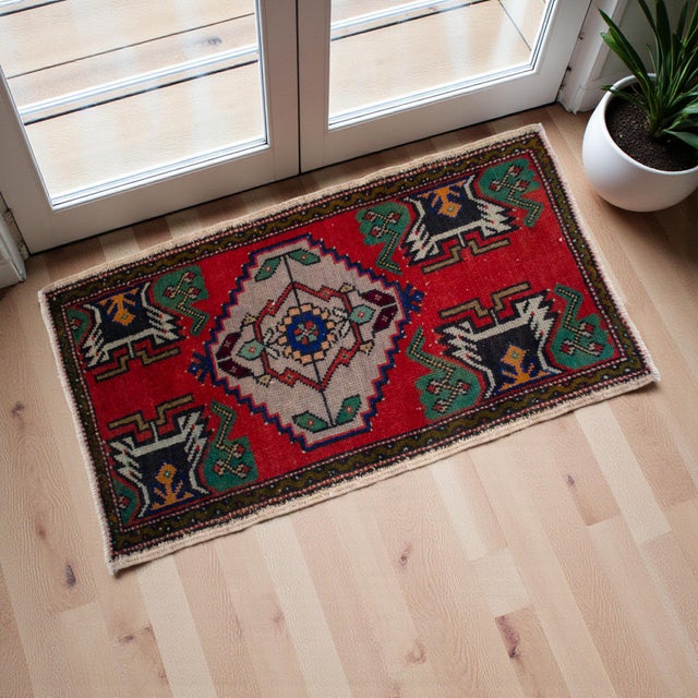 A vintage Turkish small yastik rug, degarded dark pastel red background color yastik rug perfect for entryway, bath or in...