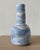 A slender American studio pottery bottle vase made in New York, finished in soft powder-blue and cream glazes over a...