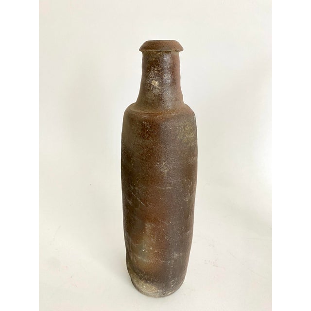 Hand-thrown in the 19th century in the Normandy region of France, these bottles were made from sandstone to hold Calvados,...