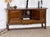 Danish sideboard in dark stained oak by Henning Kjærnulf, dating from the 1960s. Its broad, low-set cabinet, carved legs...
