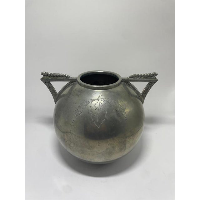 Elegant and rare Swedish pewter vase designed by Lundin & Lundberg (L&L), dating to 1935. This rounded vessel features...