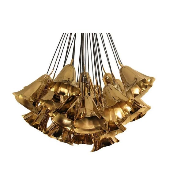 Chandelier consists of a hand sculpted metal calla lilies freely suspended from a group of strings. Structure: Gold plated...