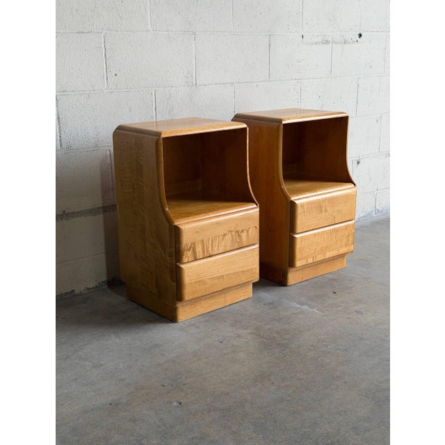 This exceptional pair of bedside cabinets features a distinctive open upper alcove above smooth gliding storage drawers....