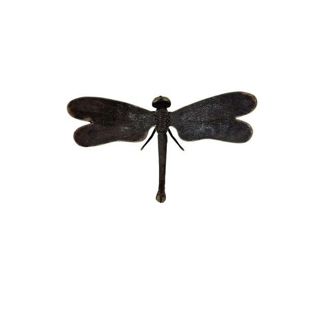 An elegant cast bronze dragonfly sculpture, capturing the fleeting grace of this iconic insect in a timeless and enduring...