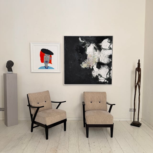 This elegant pair of 1950s lounge chairs is a fine example of mid-century European design, combining clean modernist lines...