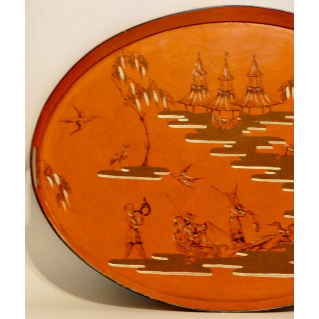 Statement size antique French chinoiserie serving tray hand painted and lacquered. It features a vibrant burnt orange...
