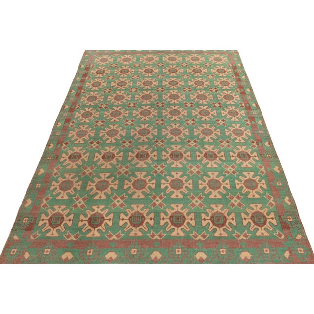 Originating from Turkey circa 1950-1960, a finely handwoven wool vintage kilim rug featuring tribal motifs culminating...