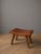 An elegant mid century modern ottoman stool dating from the 1960s This brutalist inspired accent piece features a...