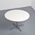 Round table designed by Charles and Ray Eames for Herman Miller, circa 1970. It consists of a circular white tabletop...