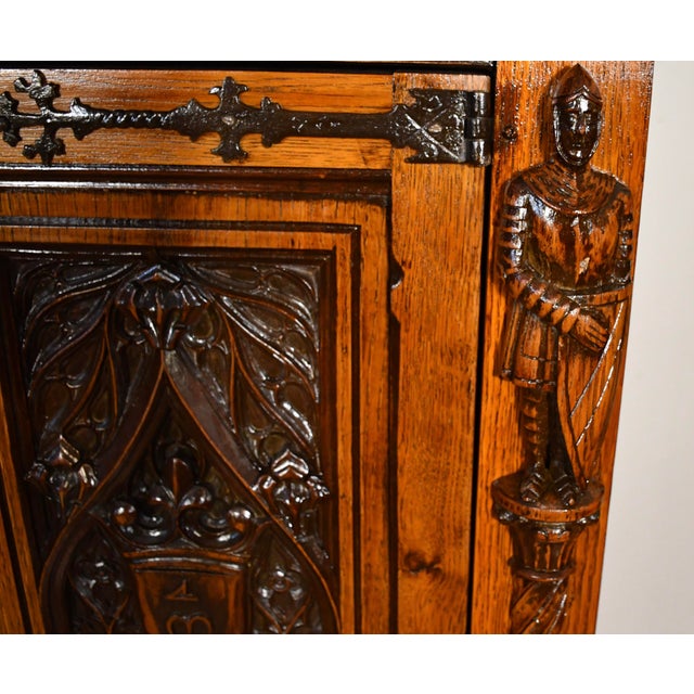 An extraordinary Gothic Revival cabinet on stand, masterfully crafted with remarkable architectural and ecclesiastical...
