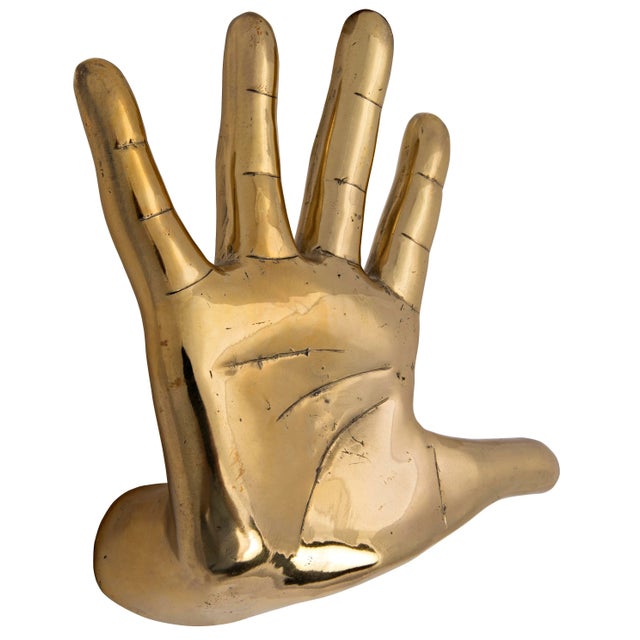 An open hand is rendered simply in an expertly weathered warm antique finish. Featuring raw, stylized lines, this...