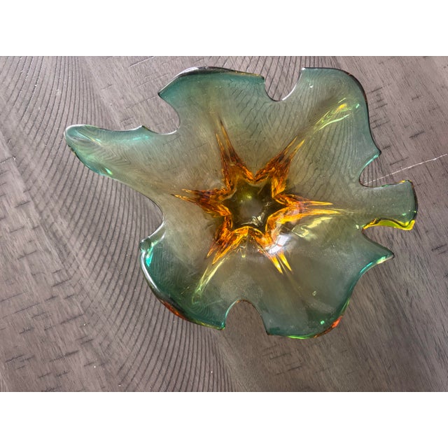 This vintage Murano art glass dish showcases the organic beauty and craftsmanship of Italian glassmaking. The piece...