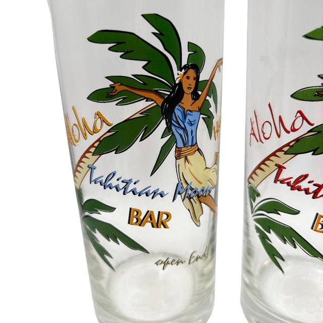 This striking set of three vintage-style tiki highball glasses. Each clear, tapered glass features a colorful, stylized...