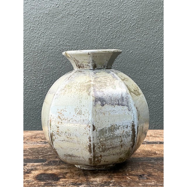 Vintage Studio Pottery Ceramic Vase with a rounded, bulbous body, slightly flared neck, and understated vertical ridges...