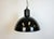 Industrial factory hanging lamp made in former Czechoslovakia during the 1950s. It features a black enamel shade with...