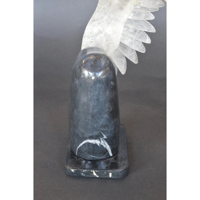 Rock crystal eagle mounted on a black marble base. Beak and talons are gilded bronze.