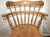 Vintage captain’s swivel barstool with a spindle high back and metal footrest. Turned spindle legs and armrest supports...