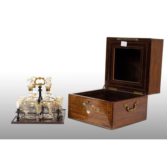 An antique Carlo X liqueur box dating from the early 19th century. The box, made entirely of exotic wood, is embellished...