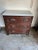 Beautiful small scale chest of drawers with marble top. The handles have a carved botanical design.
