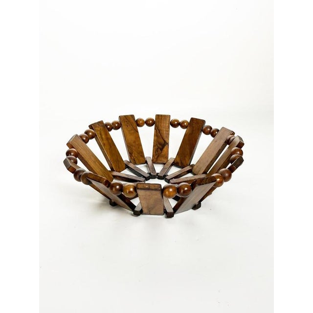 French decorative fruit basket dating from the 1970s. Crafted from wood, it features an openwork circular construction...