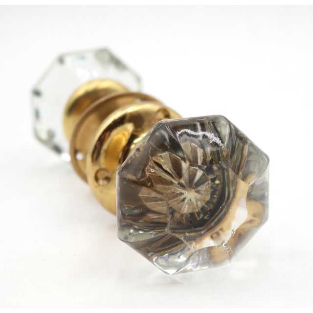 Vintage door knob set with octagon shaped clear glass door knobs paired with newly made brass rosettes. Priced as two door...