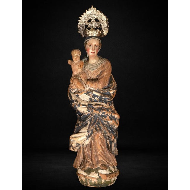 A charming carved and polychromed wooden Virgin and Child, attributed to the Italian School and dating to the 16th...